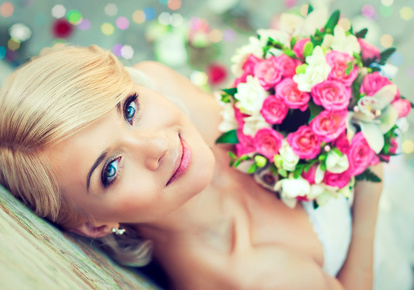 Beautiful blonde bride with a bouquet of flowers
